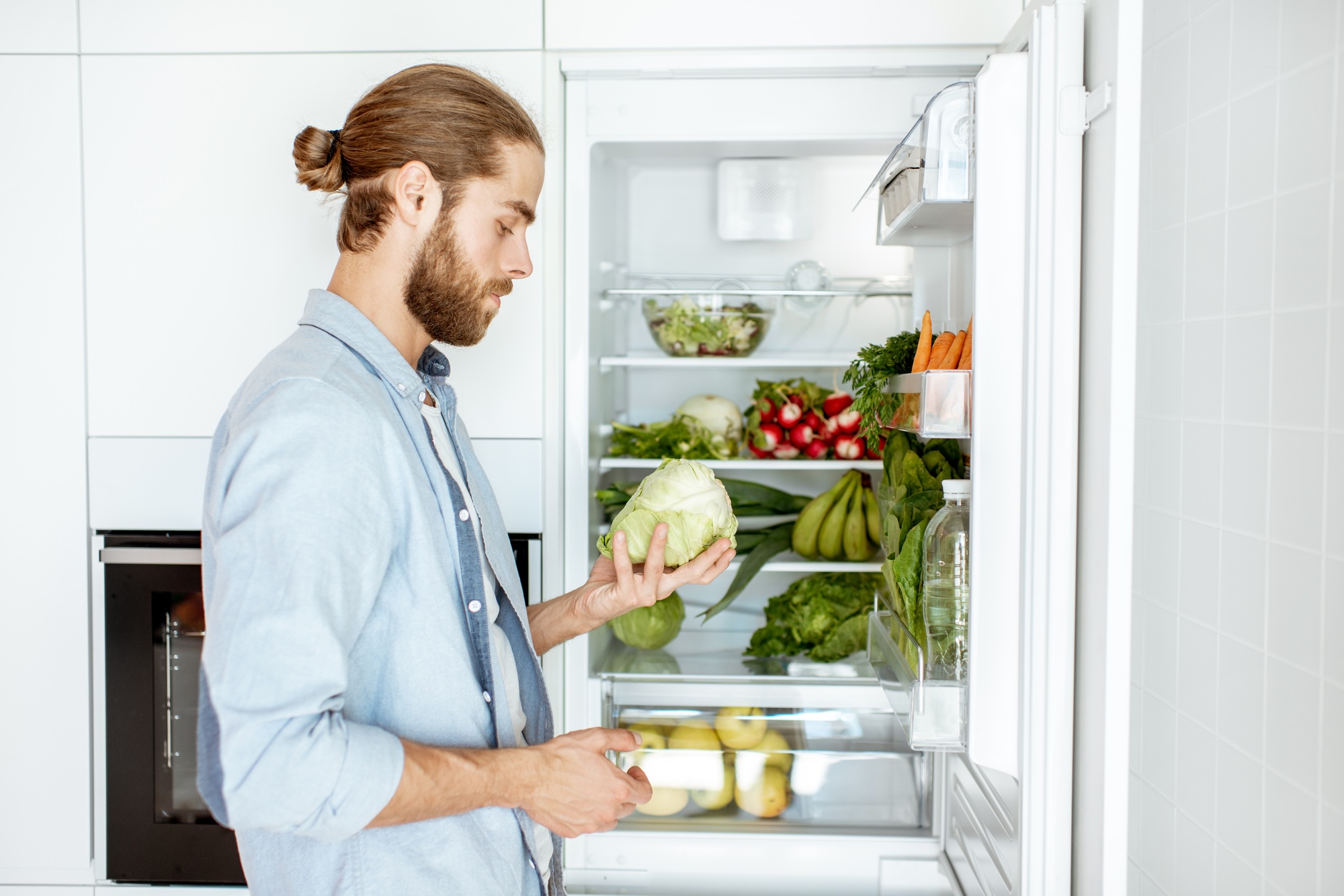 Man with fresh vegetables at the kitchen